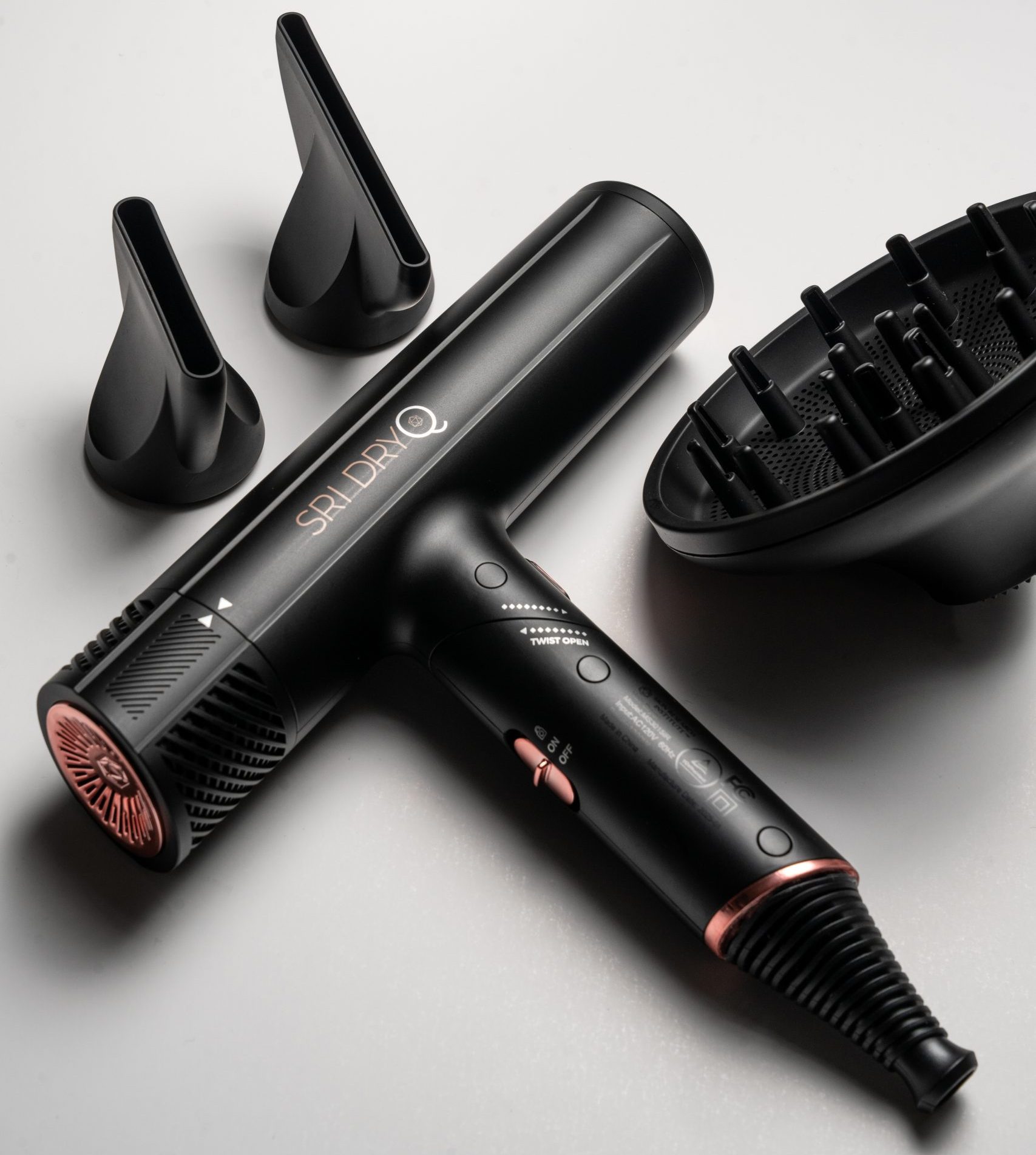 Woman styling hair using the SRI Q hair dryer at home